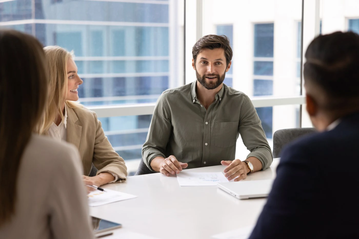 Consulting team reviewing reports around a conference table