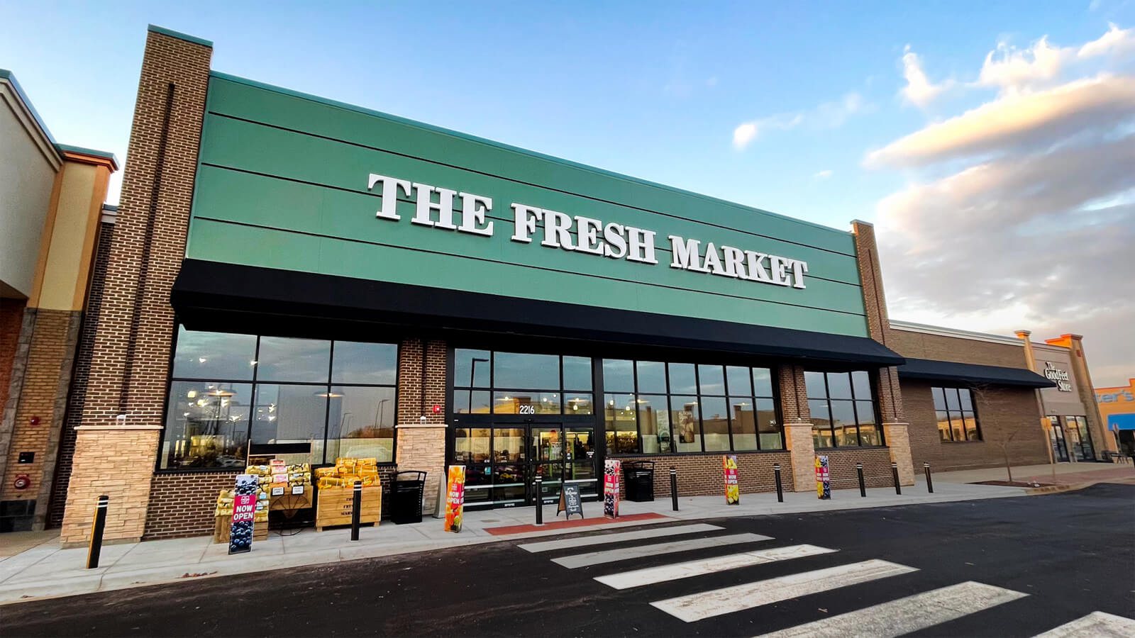 The Fresh Market storefront at dusk