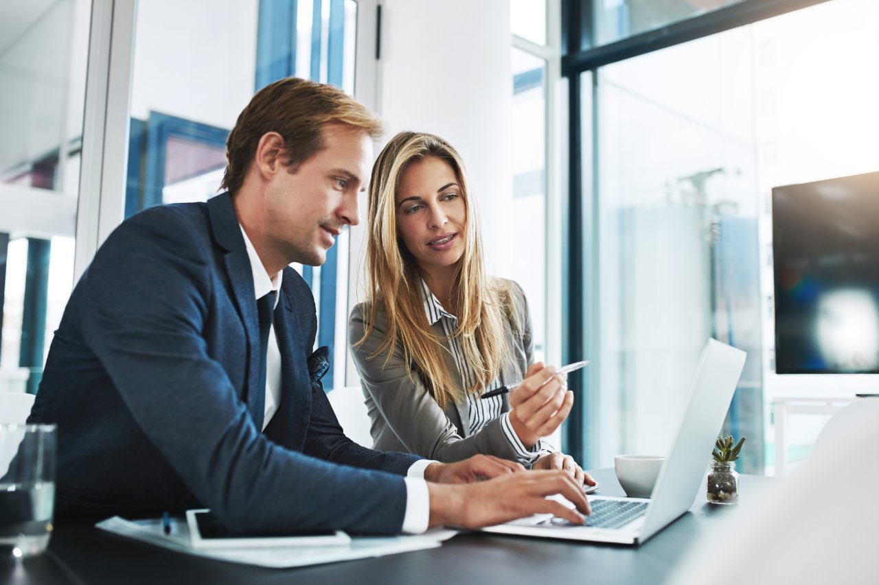 Two Mosaic consultants reviewing work together at a laptop