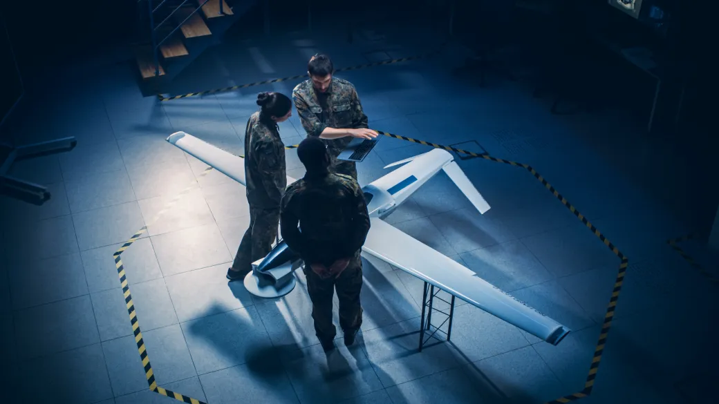 Aerospace technicians working on an airframe assembly