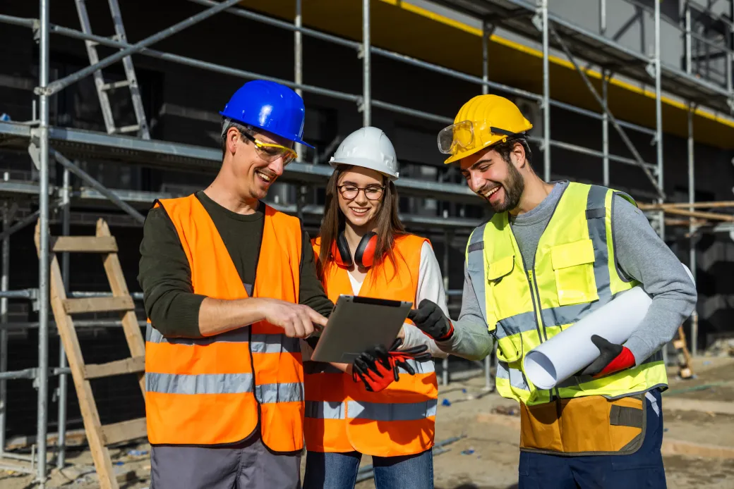 Site managers reviewing plans on a construction site