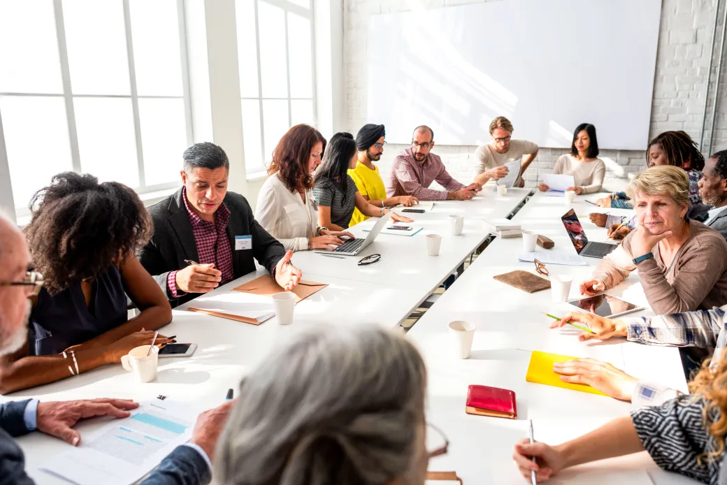 Mosaic consultants collaborating around a long boardroom table