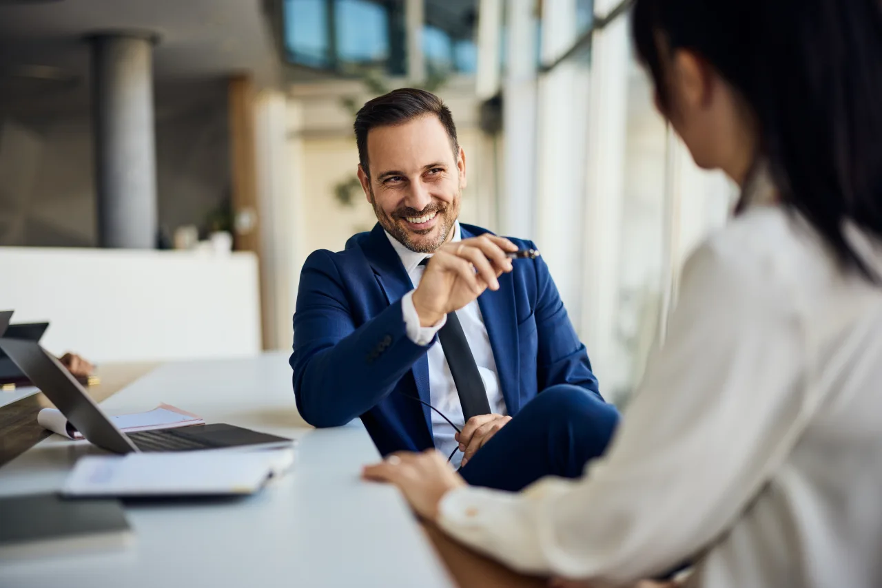 A Mosaic consultant talking with a client across a desk
