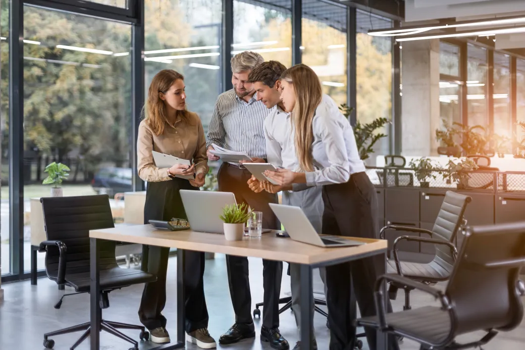 Consultants reviewing documents together at a meeting table