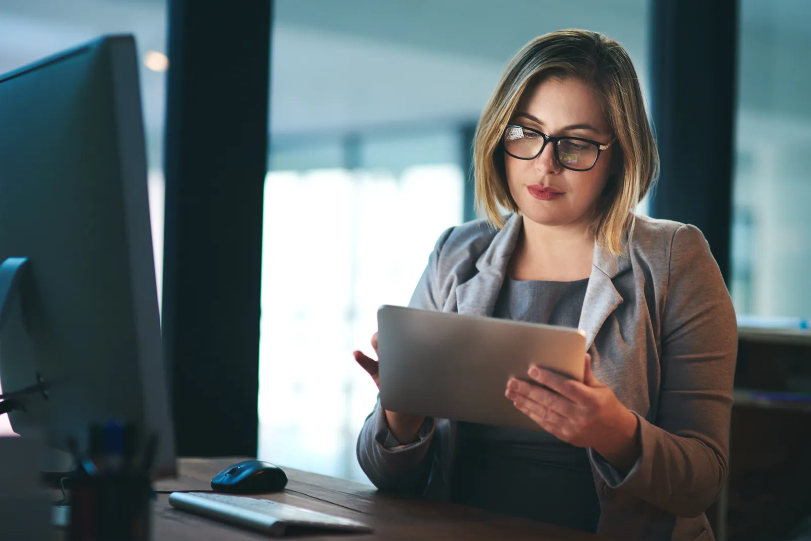 UKG consultant reviewing workforce data on a tablet