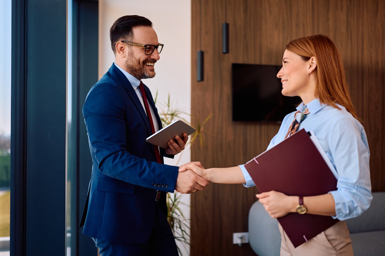 Mosaic consultant shaking hands with a client in an office